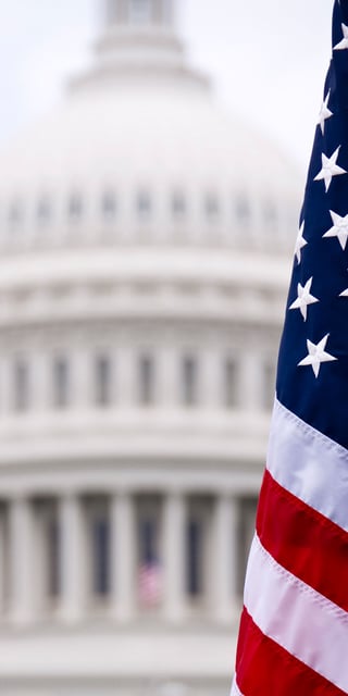 us capital building with american flag in the foreground
